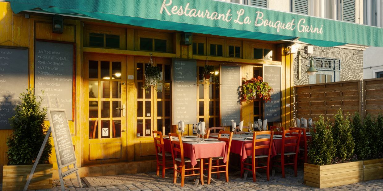 Cozy outdoor seating with red chairs at Restaurant La Bouquet Garni.