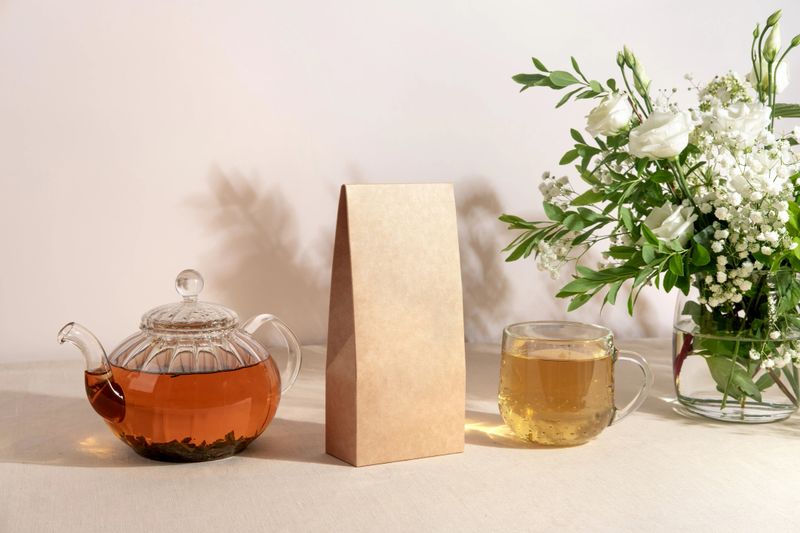 Tea branding and packaging mockup. Blank tea packaging mockup with tea. Kraft paper pack  and empty space to display your branding design.