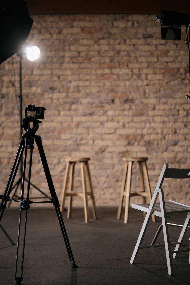 Modest backstage studio with recording equipment, lights and chairs setup and no people in it