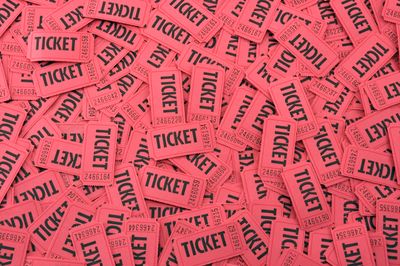 Pile of pink raffle tickets scattered randomly.