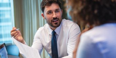 Man discussing documents in an office.