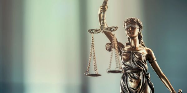 Statue of Lady Justice holding scales and sword.