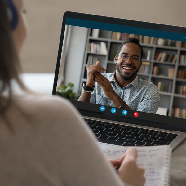 Person video chatting on a laptop.