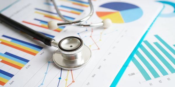 Stethoscope on charts with medical data.