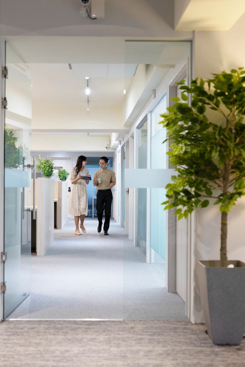 Asian businessmen walking on the hallway and discussing the working content.