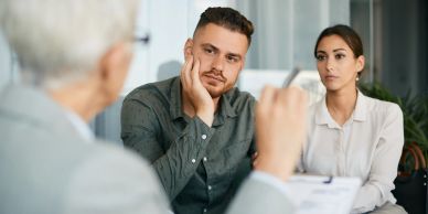 A bipoc couple listens as they talk about Collaborative Divorce with a therapist.
