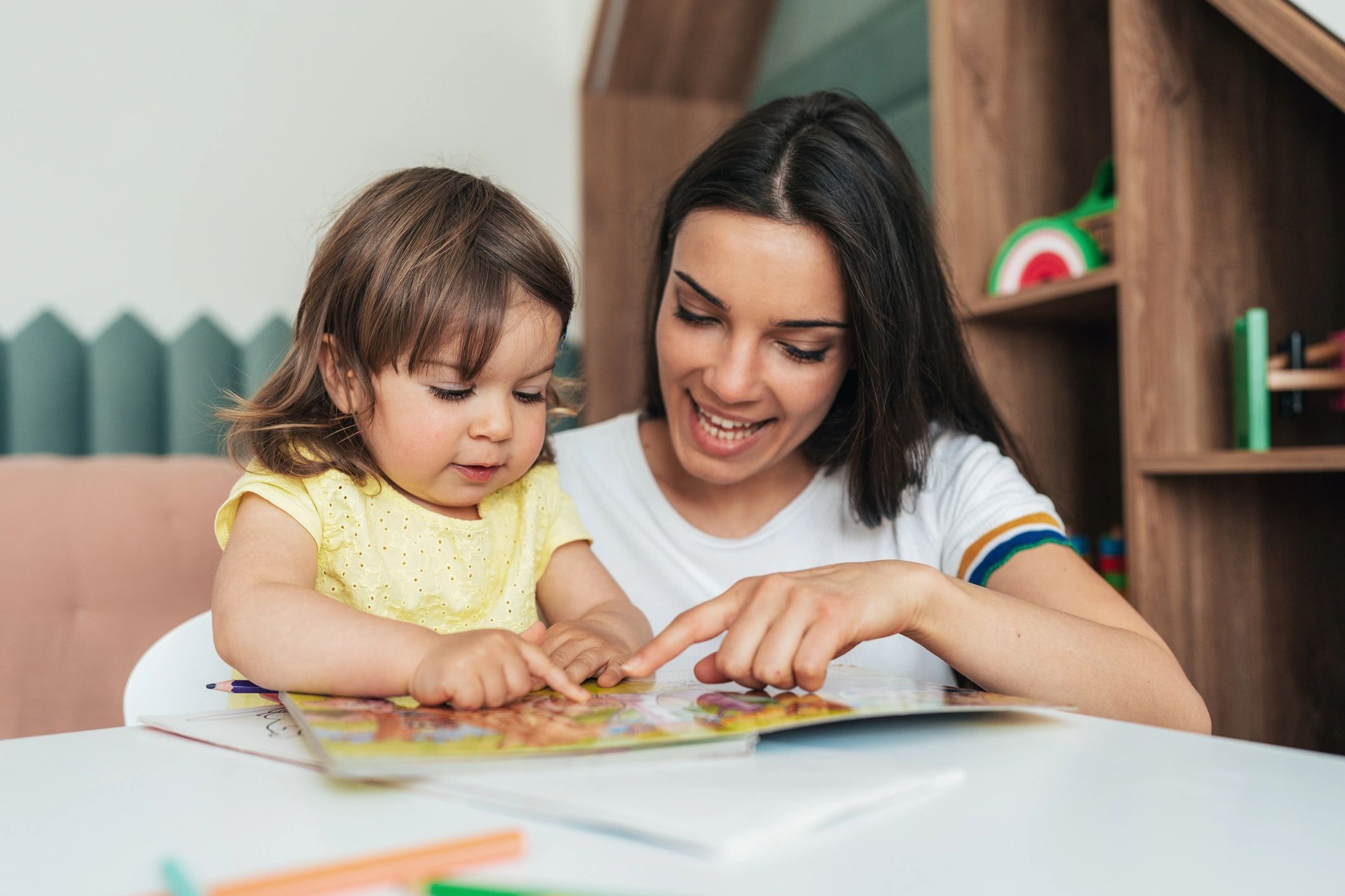 Mother reading a book with her toddler.