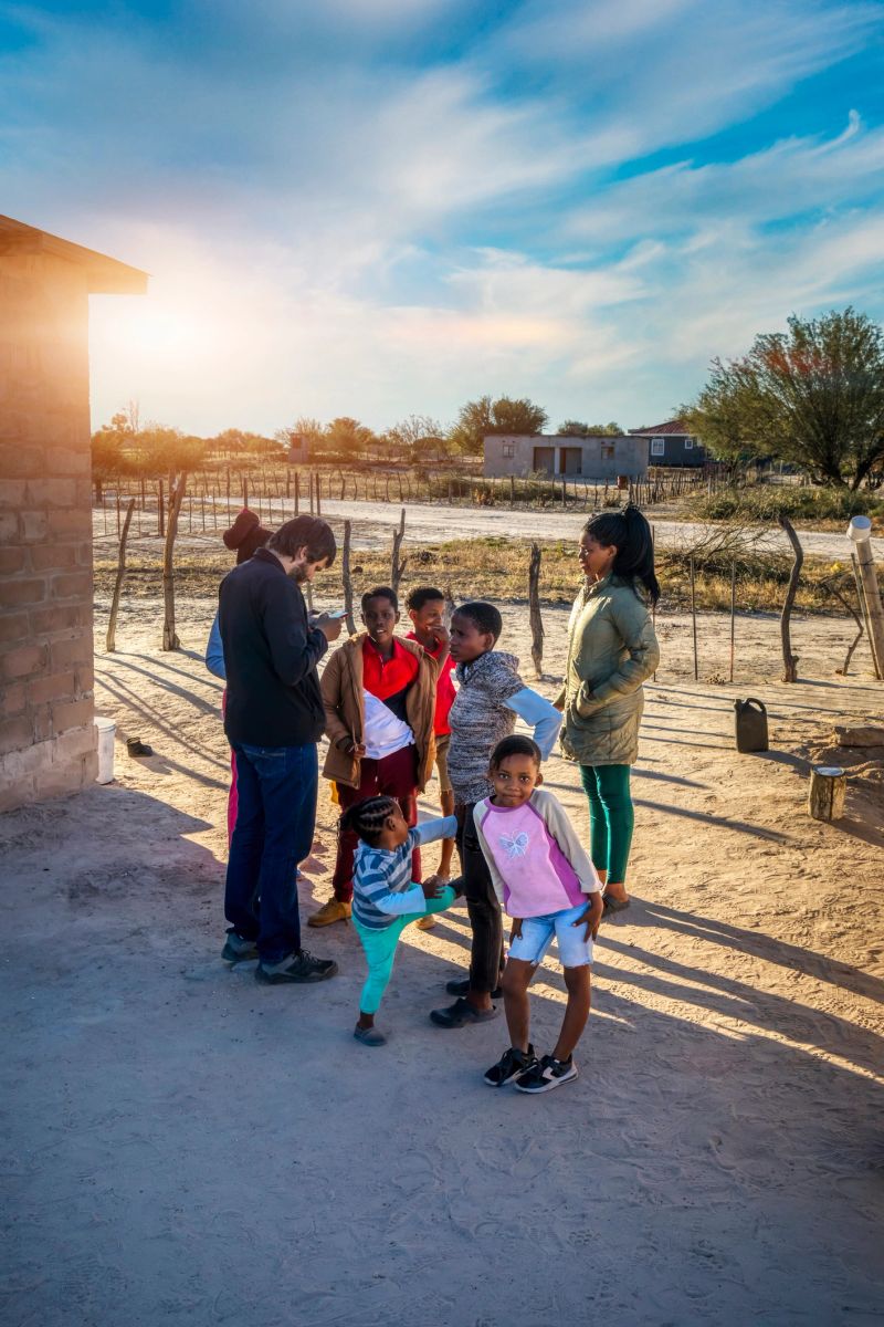 social worker in contact with an African family in a village