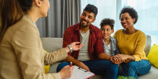 Family consulting a professional in their living room.