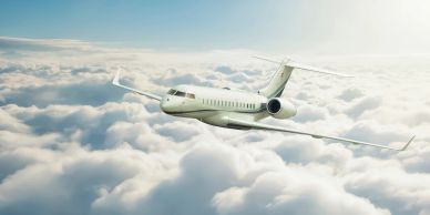 Private jet flying above clouds.