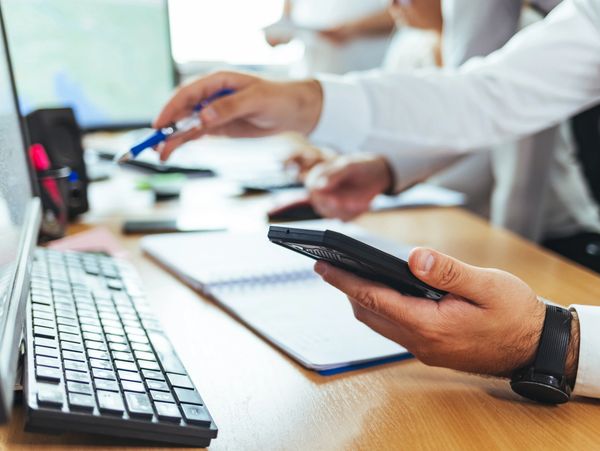 Person using calculator and keyboard for work or study.