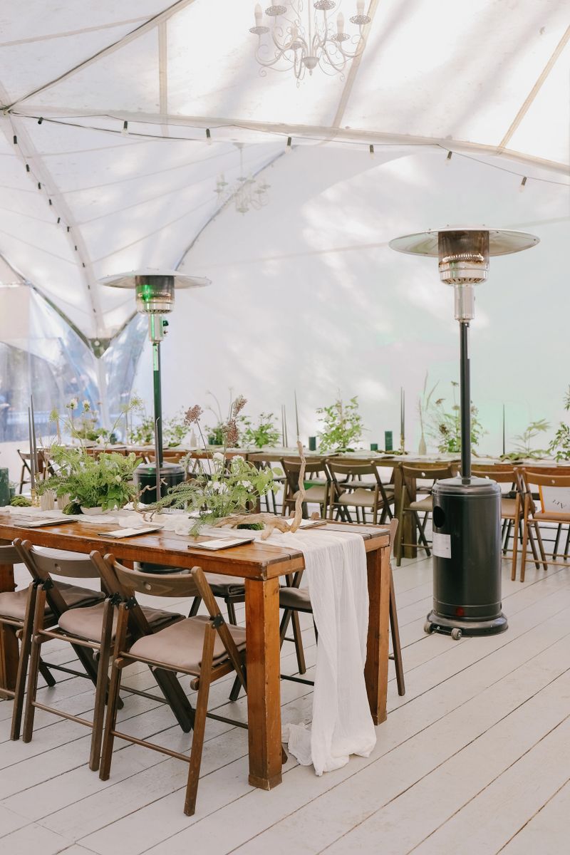 wedding decor decoration for a wedding ceremony or birthday. flowers and candles on festive boho tables. wedding in the forest in a beautiful tent, florists and decorators create a beautiful holiday atmosphere