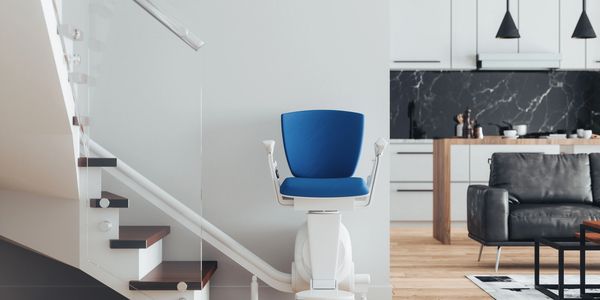 an image of a nice modern home with a nice looking stair lift leading up the stairs. 