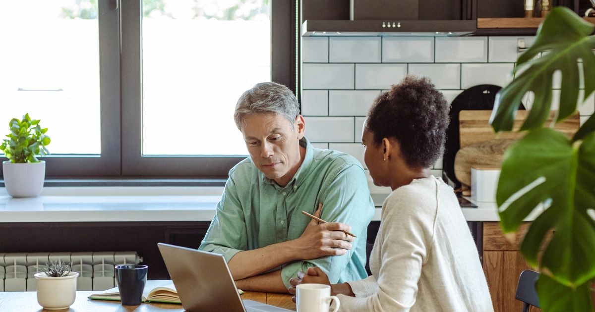 Divorcing couple reviewing home documents and mortgage paperwork