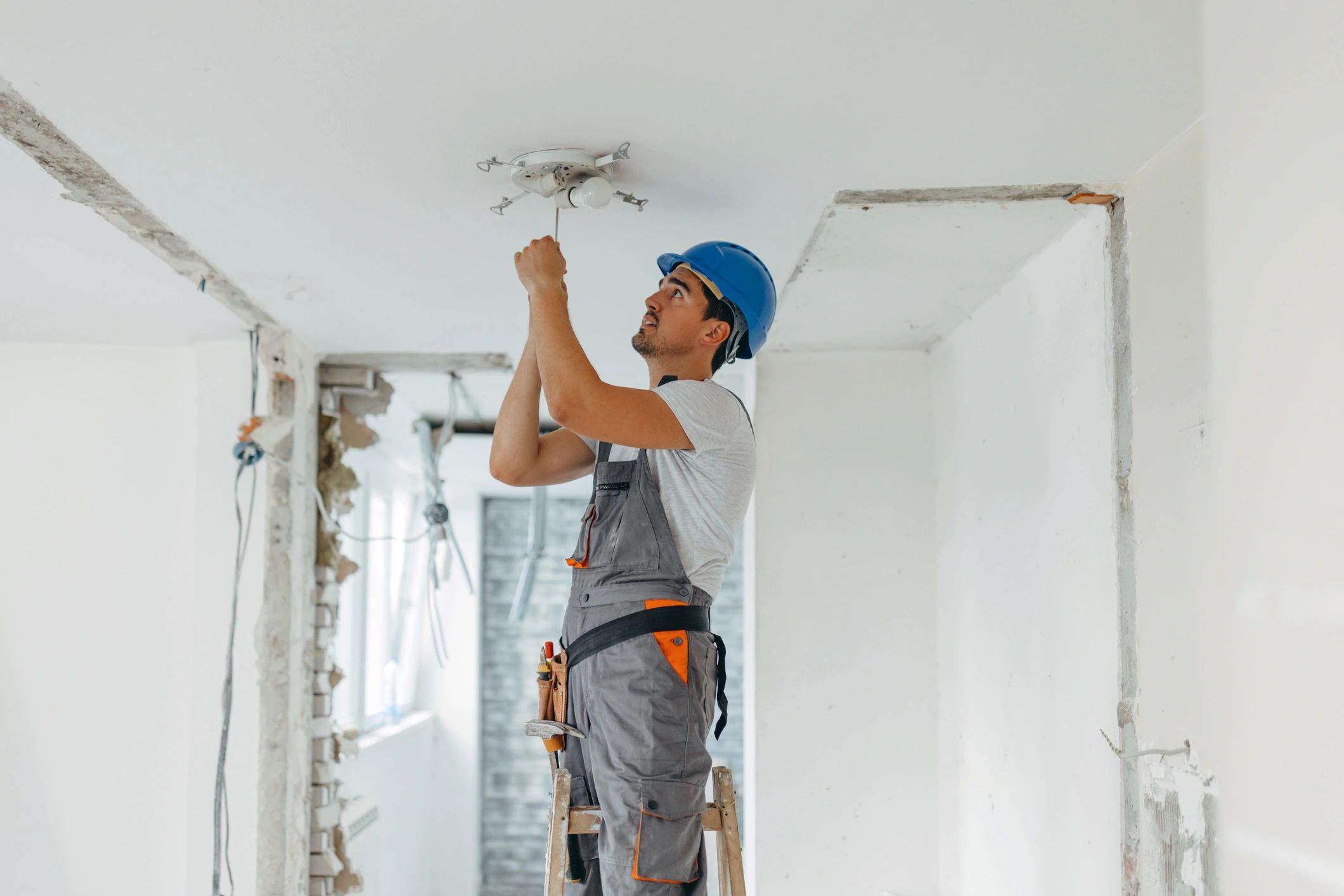 Stack of books next to pencils in a holder and a camera.