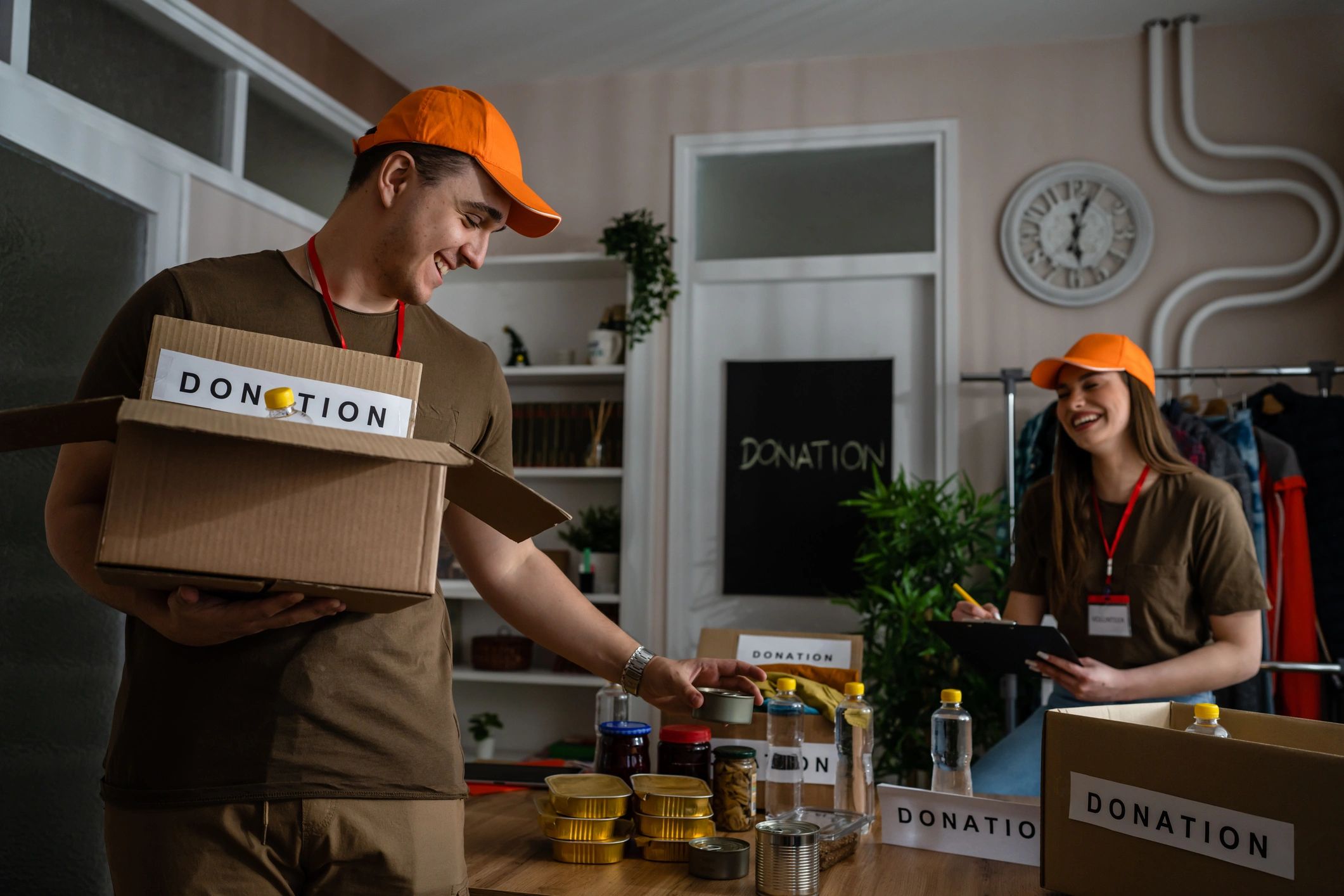 Volunteers preparing donation boxes with food and supplies.