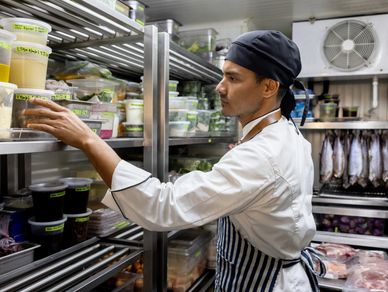 Walk-in commercial refrigerator with organized food storage, highlighting reliable refrigeration per