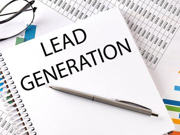 Notebook with 'Lead Generation' text and a pen.