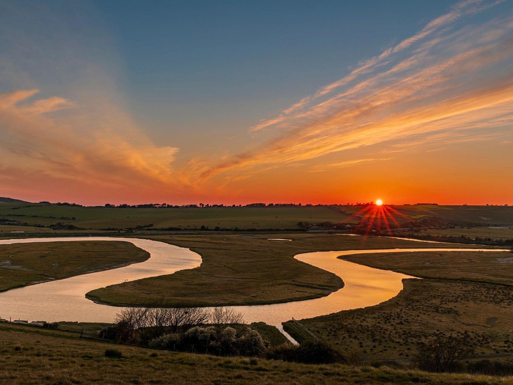 river cuckmere, winding river, sunset, refelction of the golden sun at sunset on the water, beautifu