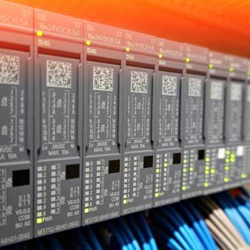Close-up of industrial automation control modules with LED indicators and cables.