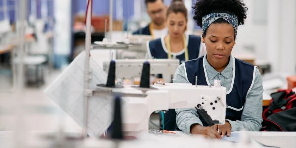 Women working on sewing machines in a garment factory.