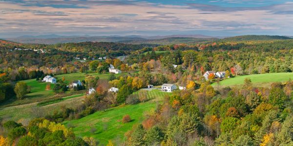 Aerial view of a peaceful rural landscape with houses and trees.