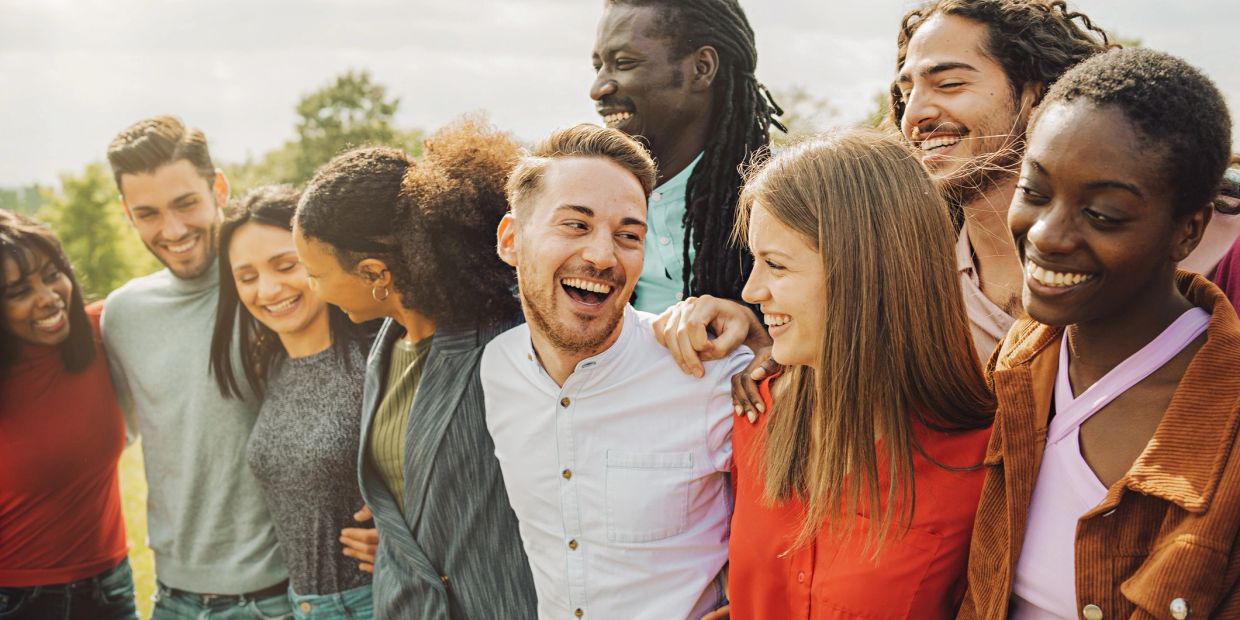 Group of diverse friends smiling outdoors.