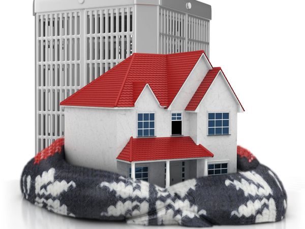 A house and air conditioner wrapped in a cozy knitted scarf.