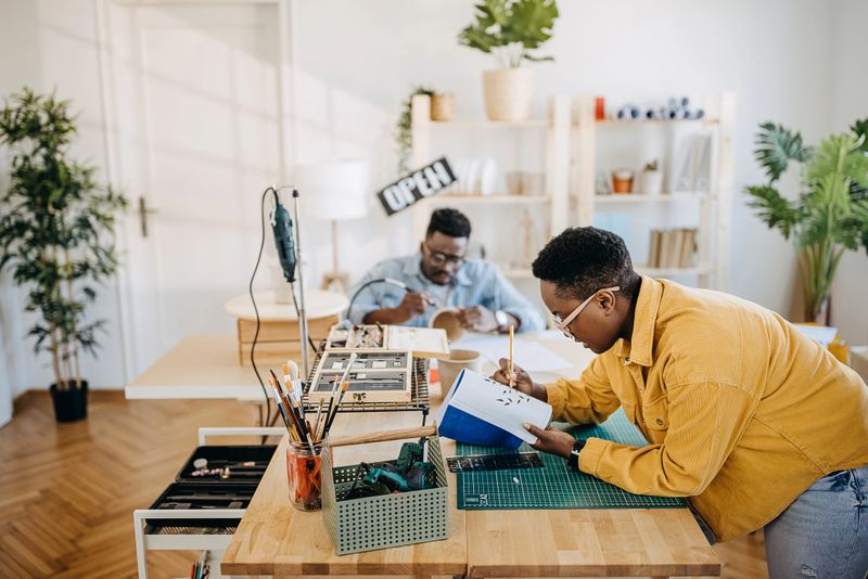 Couple working together in their small craft studio