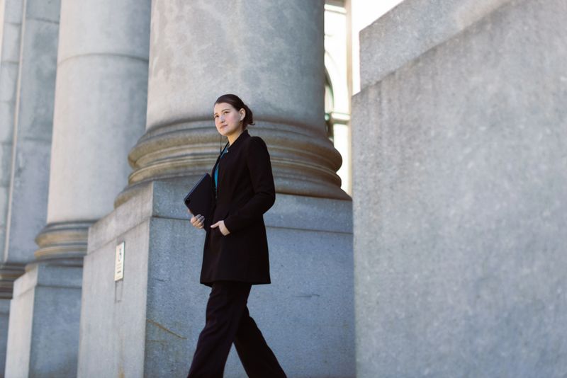 Hispanic latin female lawyer in front of the court house. Downtown Manhattan, New York, USA