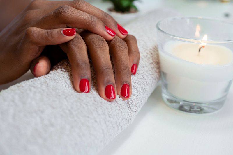 Close up of female hands having manicure spa treatment at beauty salon