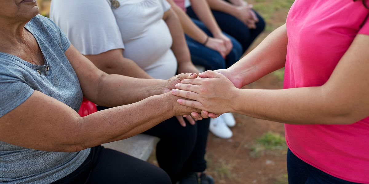 People holding hands in support group
