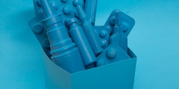 Blue monochrome plastic toy building blocks in a container.