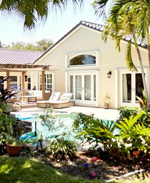 Elegant backyard with stone patio and lush landscaping.