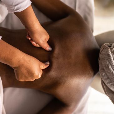 Massage therapist giving a back massage.