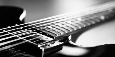 Close-up of a guitar's strings and fretboard.