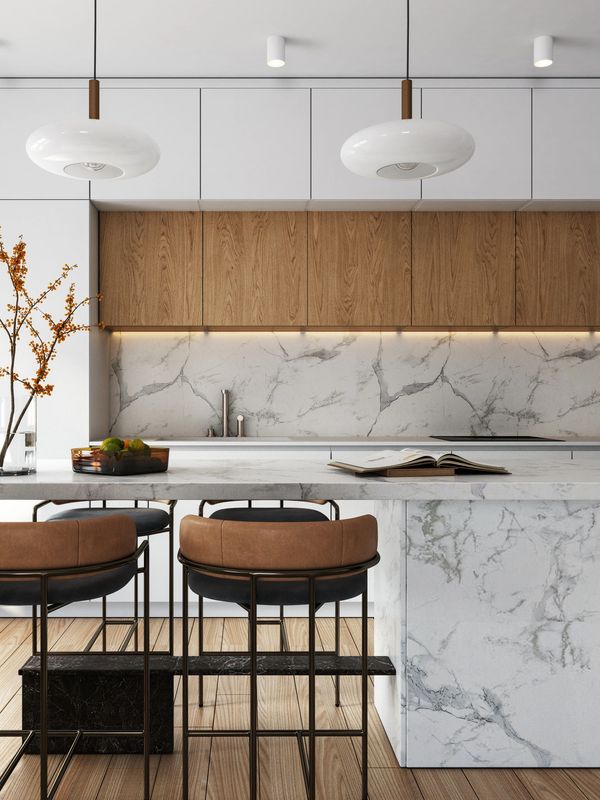 Modern kitchen with marble countertops and wooden cabinets.