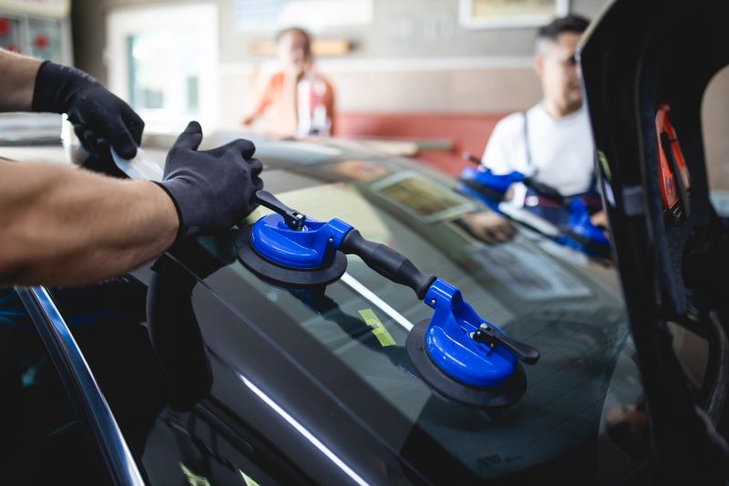 Expert technicians repairing a car windshield at Discount Auto Glass FC