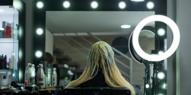 Person getting hair treatment in a salon with professional lighting.
