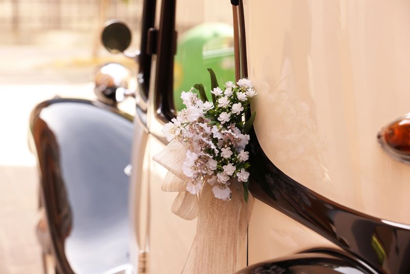 An old classic car sitting in the street