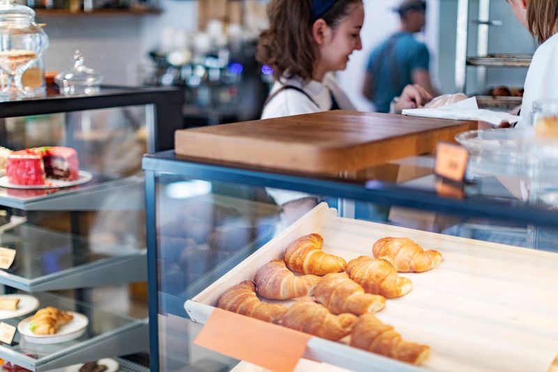 Bakery and pastry store showcase with tasty buns