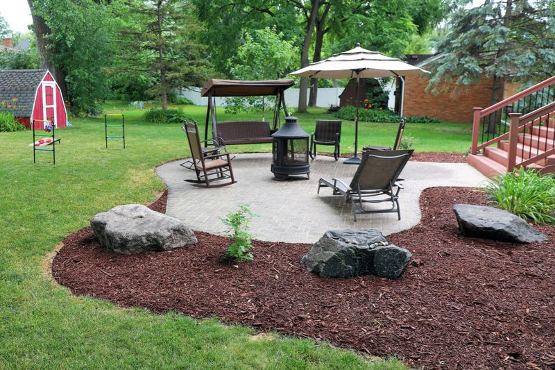 Man mulching yard in suburban house