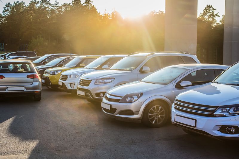 Cars in the parking lot in the evening at sunset lit by the sun
