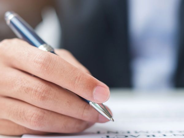 Young woman taking notes with a pen