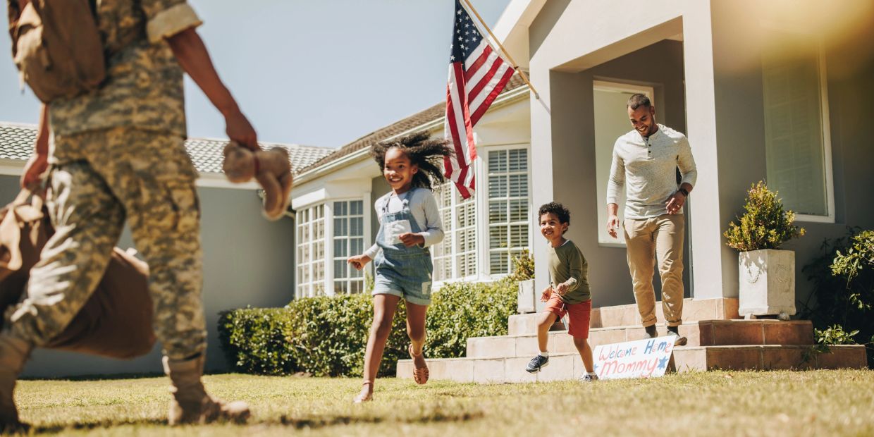 Children and father welcome home soldier.