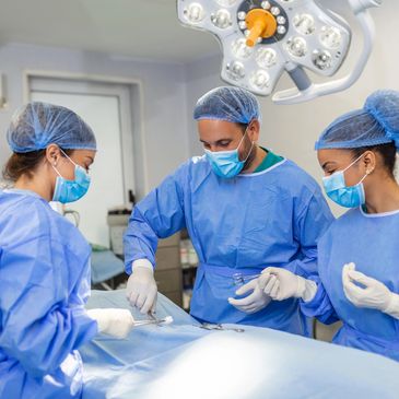Surgical team performing an operation in a sterile operating room.