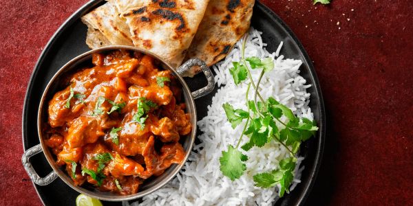 Indian meal with curry, rice, and flatbread.