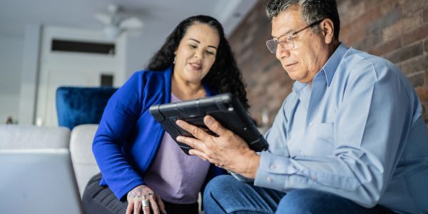 Man and woman looking at a tablet together.