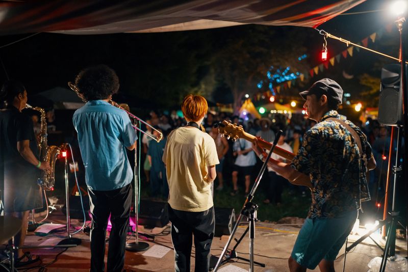 Jazz group playing a live concert at an outdoor music festival at night in Japan