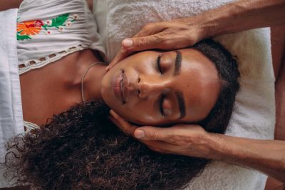 Woman receiving a relaxing face massage.
